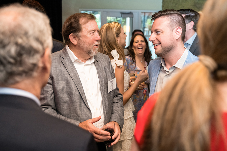 2 men talking at a gathering