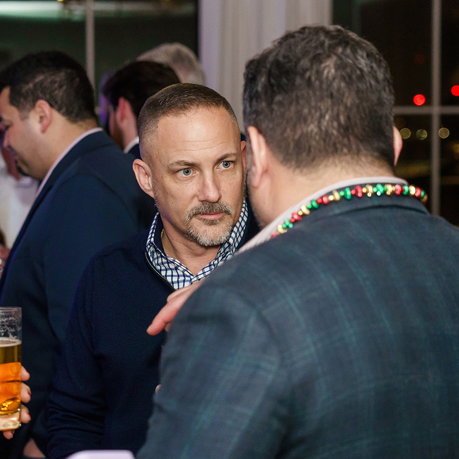 men talking at a party