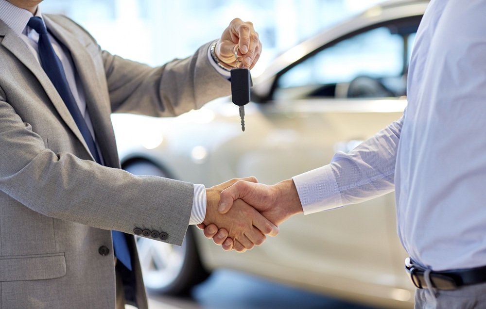 close up of handshake in auto show